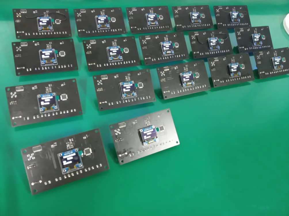 Custom LoRa communication boards with powered displays on a workbench