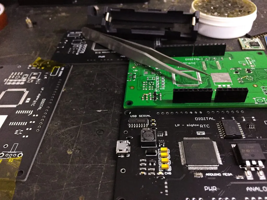 Electronics boards and assembly tools on a development workbench